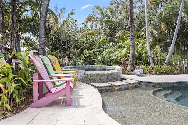view of swimming pool featuring an in ground hot tub