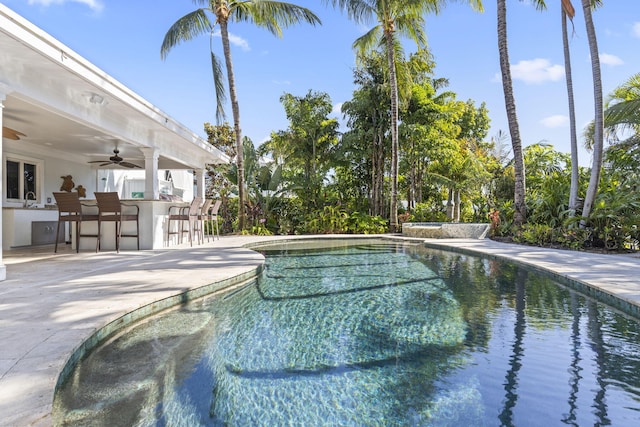 pool featuring a patio, a sink, outdoor dry bar, and a ceiling fan