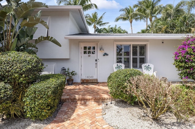 property entrance with stucco siding
