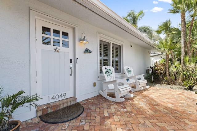 property entrance with stucco siding