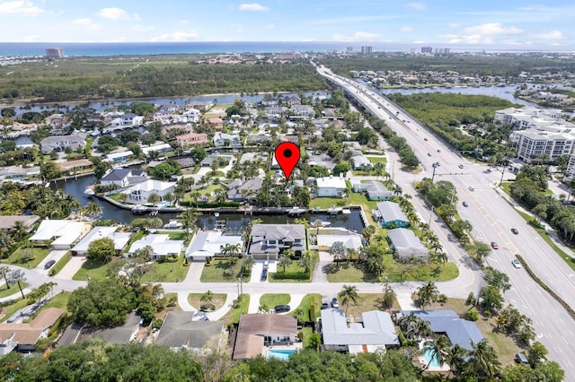 drone / aerial view featuring a residential view and a water view