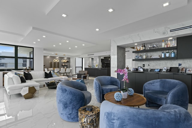 living room with recessed lighting, indoor wet bar, and marble finish floor