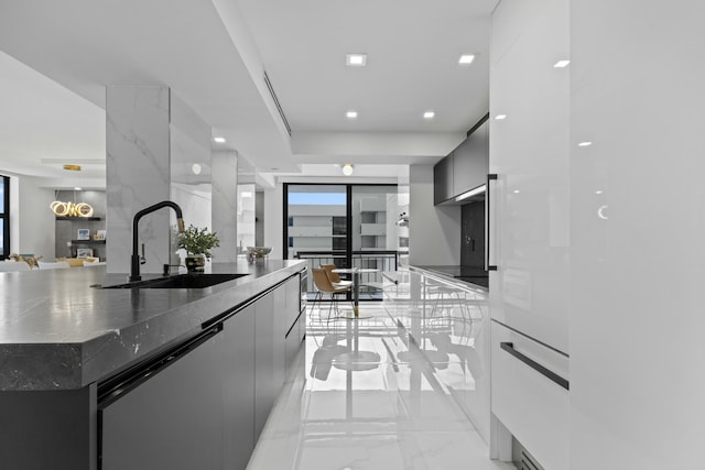 kitchen with dishwashing machine, modern cabinets, marble finish floor, and a sink