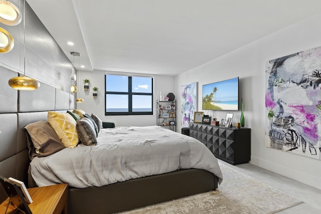 bedroom featuring recessed lighting, concrete floors, and baseboards