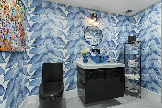 bathroom with visible vents, wallpapered walls, and vanity