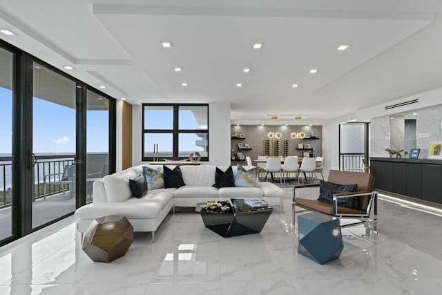 living room with recessed lighting, expansive windows, and marble finish floor