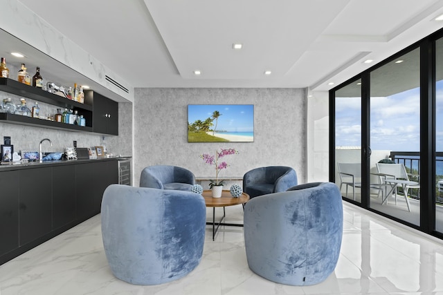 living room with indoor wet bar, recessed lighting, marble finish floor, and floor to ceiling windows