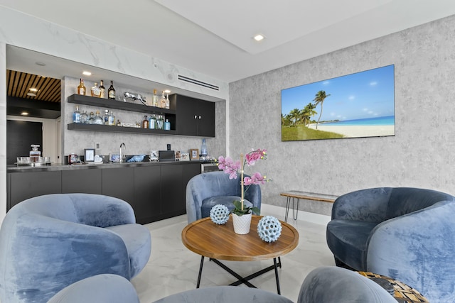 living area featuring indoor wet bar, recessed lighting, and marble finish floor