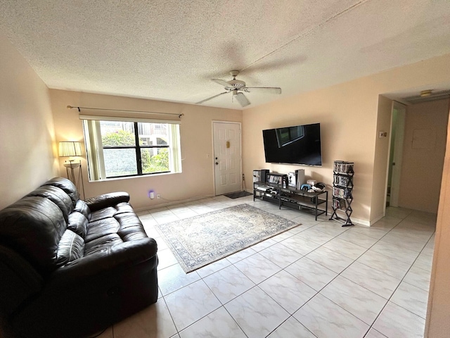 living room featuring light tile patterned flooring, a textured ceiling, and a ceiling fan