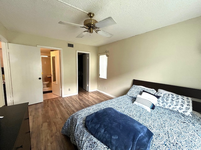 bedroom with a ceiling fan, baseboards, wood finished floors, visible vents, and a textured ceiling