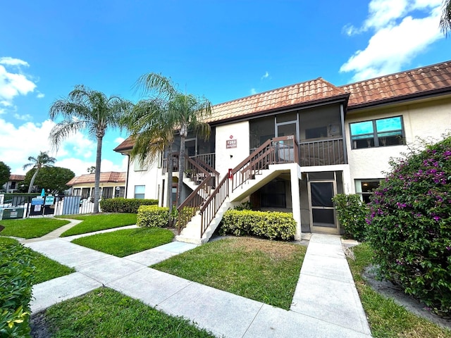 view of property with stairway and fence