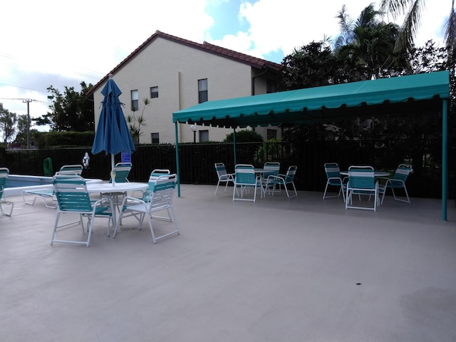 view of patio / terrace with outdoor dining space and fence