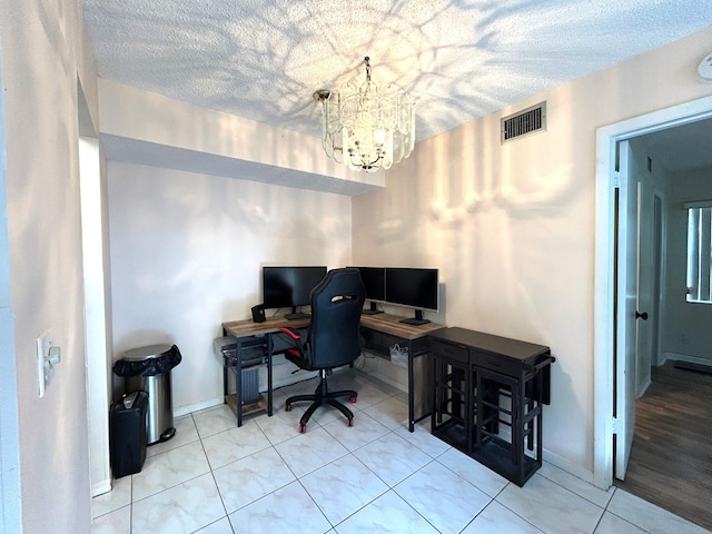 tiled home office featuring visible vents, baseboards, a textured ceiling, and an inviting chandelier