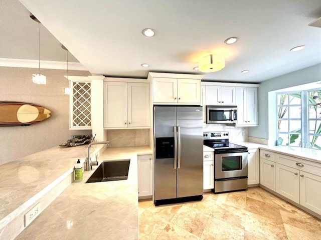 609 NE 19th Ave, Deerfield Beach, FL 33441 - kitchen featuring tasteful backsplash, light stone countertops, decorative light fixtures, appliances with stainless steel finishes, and a sink