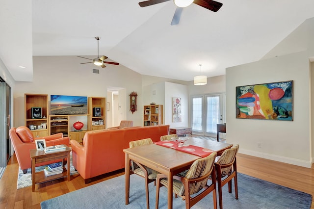 dining space featuring lofted ceiling, light wood-type flooring, and ceiling fan