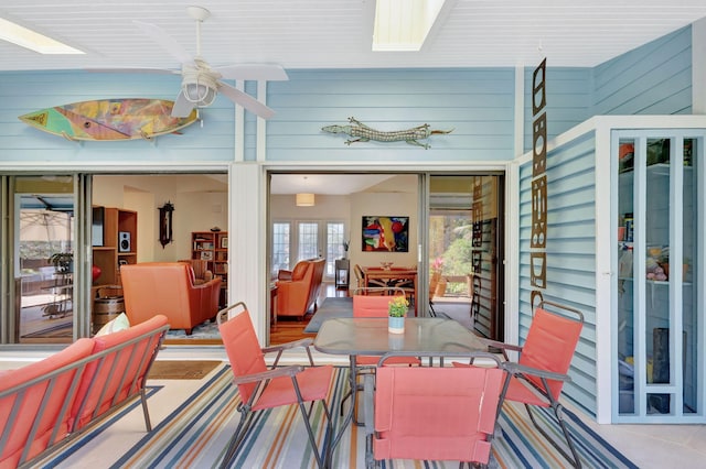 view of patio with outdoor dining area and a ceiling fan