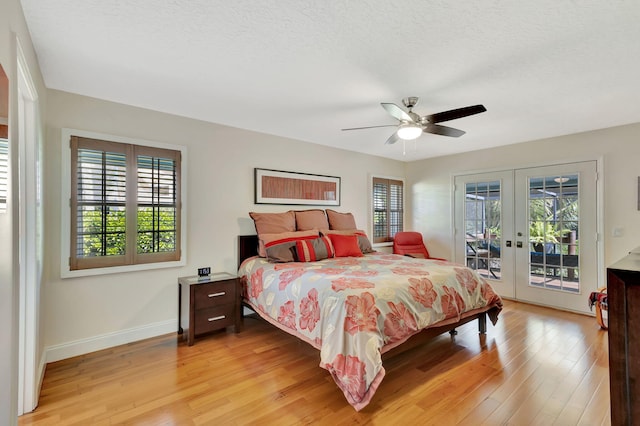 bedroom with baseboards, light wood finished floors, ceiling fan, access to exterior, and french doors