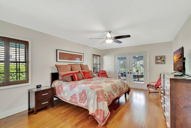 bedroom with ceiling fan, baseboards, light wood-type flooring, french doors, and access to outside