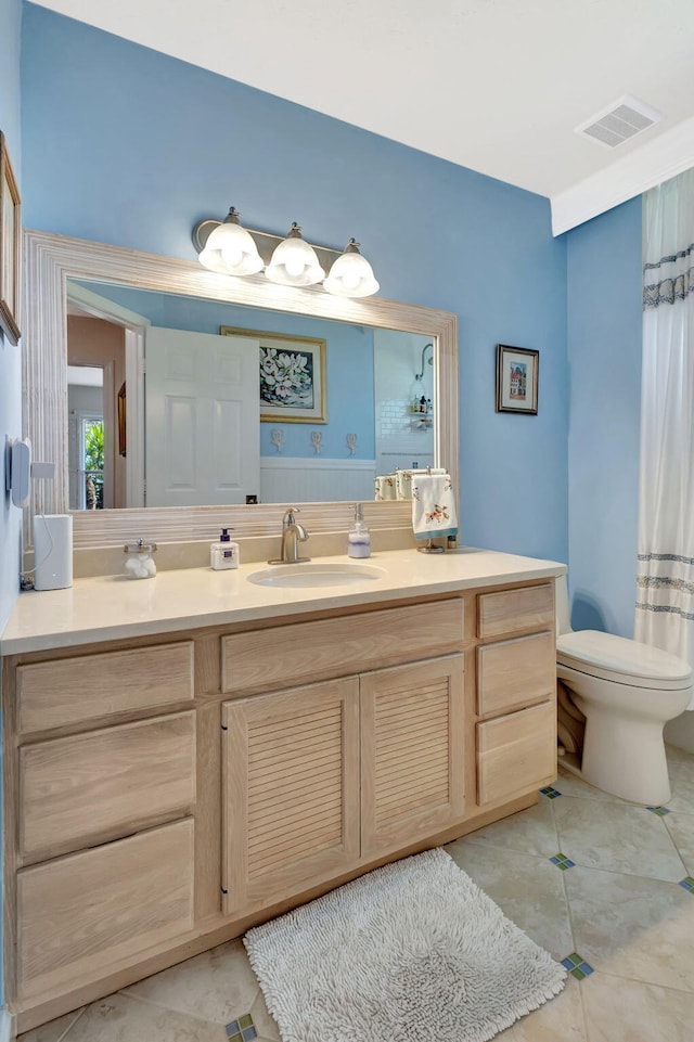 bathroom with vanity, toilet, visible vents, and tile patterned flooring