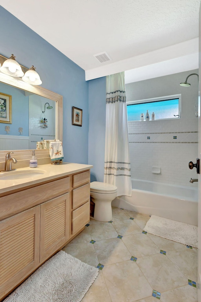 bathroom featuring visible vents, toilet, shower / tub combo, tile patterned floors, and vanity