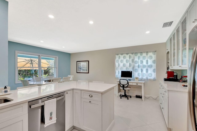 kitchen featuring glass insert cabinets, white cabinets, light countertops, and stainless steel dishwasher