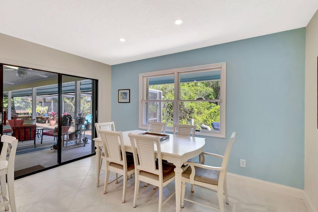 dining area featuring recessed lighting, light tile patterned floors, a healthy amount of sunlight, and baseboards