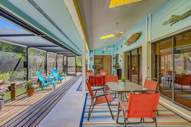 sunroom / solarium featuring lofted ceiling and a ceiling fan