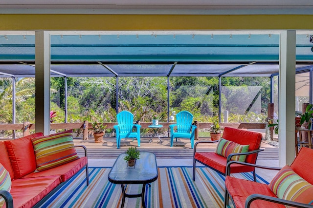 view of patio featuring an outdoor living space and a lanai