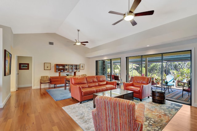 living room with a ceiling fan, visible vents, baseboards, lofted ceiling, and light wood-style floors