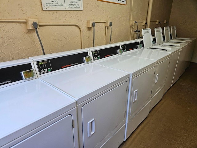 400 Village Green Cir W Unit 202, Palm Springs, FL 33461 - community laundry room featuring washer and dryer and a textured wall