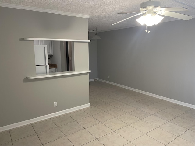 400 Village Green Cir W Unit 202, Palm Springs, FL 33461 - spare room featuring a ceiling fan, ornamental molding, light tile patterned floors, baseboards, and a textured ceiling