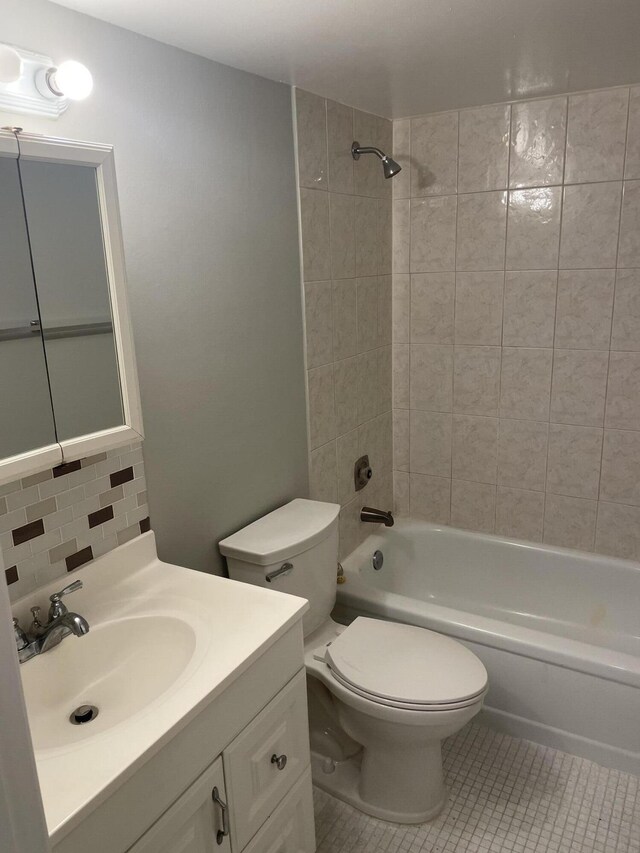 400 Village Green Cir W Unit 202, Palm Springs, FL 33461 - bathroom with toilet, washtub / shower combination, tile patterned flooring, vanity, and decorative backsplash