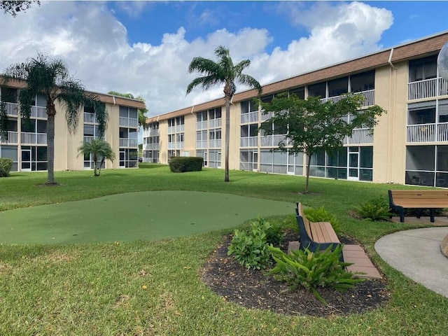 400 Village Green Cir W Unit 202, Palm Springs, FL 33461 - view of home's community with an area to practice putting and a yard