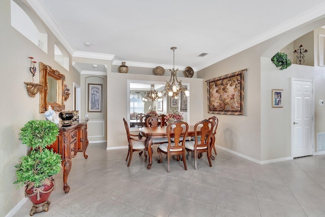 dining room with light tile patterned floors, visible vents, baseboards, and ornamental molding