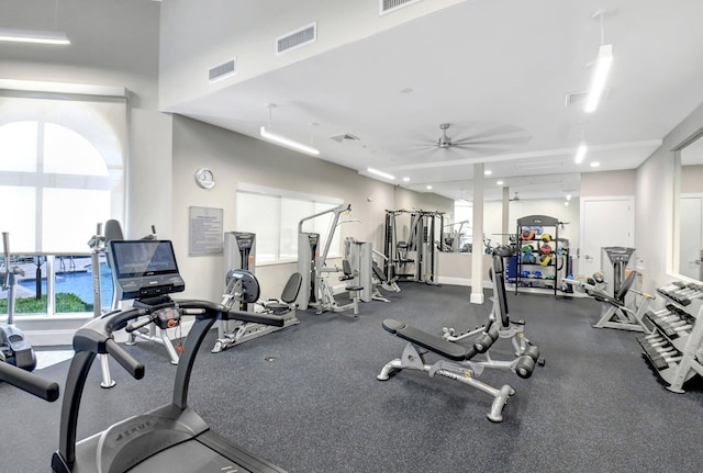 workout area with a ceiling fan, visible vents, and baseboards