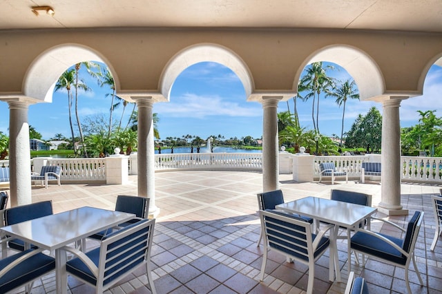 view of patio / terrace with outdoor dining area and a water view