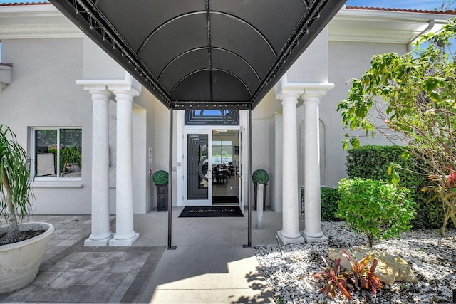 property entrance with stucco siding