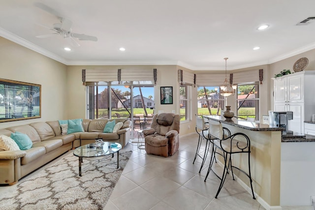 living room featuring visible vents, ceiling fan with notable chandelier, recessed lighting, crown molding, and light tile patterned floors