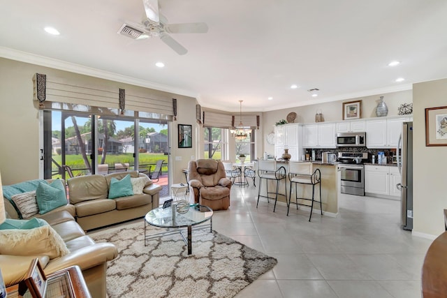 living area with light tile patterned floors, visible vents, recessed lighting, ornamental molding, and ceiling fan with notable chandelier