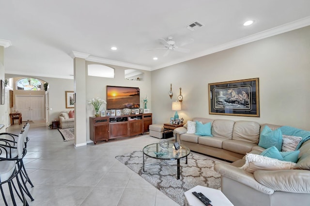 living room featuring light tile patterned floors, visible vents, a ceiling fan, and ornamental molding