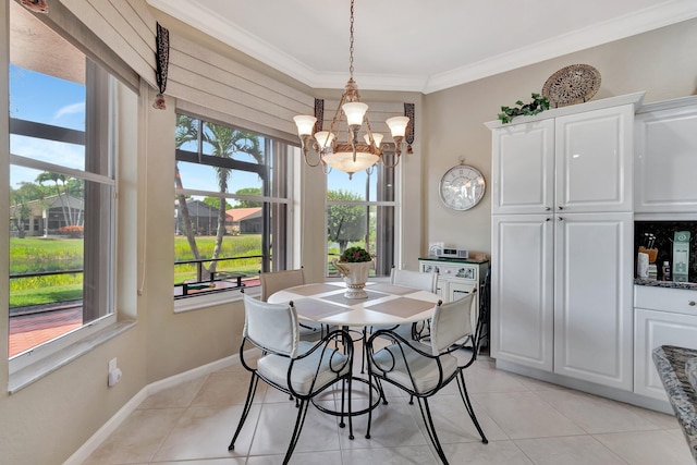 dining room with a notable chandelier, baseboards, light tile patterned floors, and ornamental molding