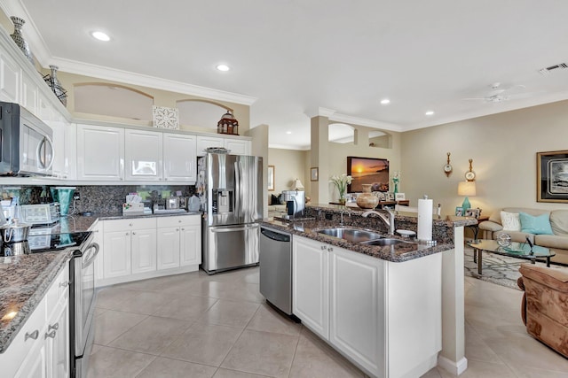 kitchen featuring visible vents, ornamental molding, a sink, appliances with stainless steel finishes, and open floor plan