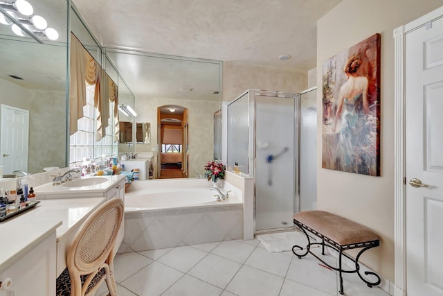 full bathroom with tile patterned flooring, a stall shower, vanity, and a bath