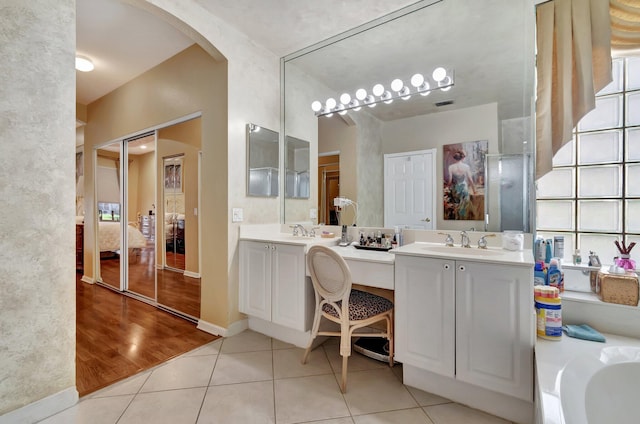 full bath featuring tile patterned flooring, visible vents, a bathtub, ensuite bath, and vanity