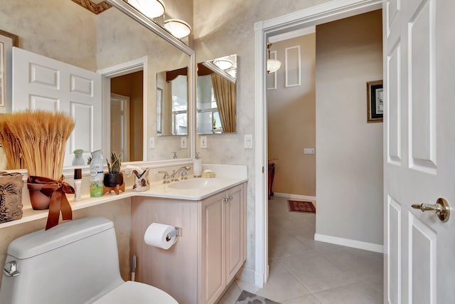 bathroom featuring tile patterned floors, toilet, vanity, and baseboards