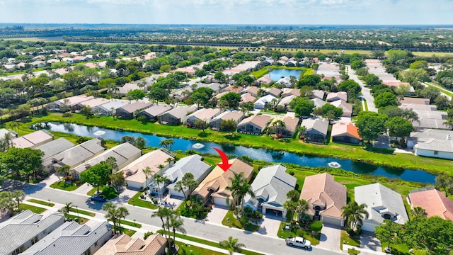 drone / aerial view featuring a residential view and a water view