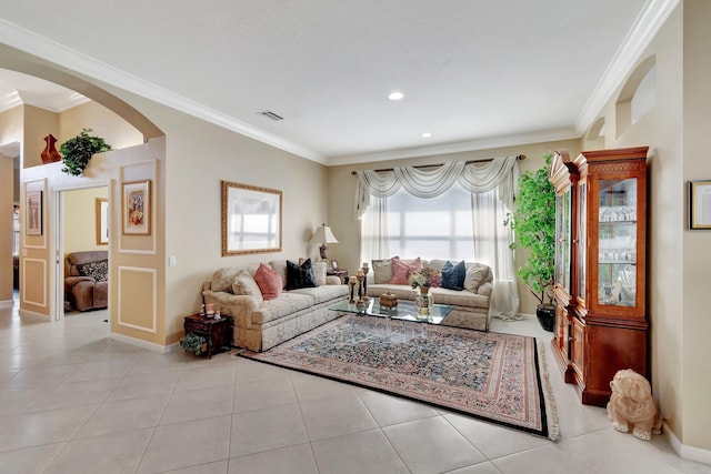 living area featuring visible vents, crown molding, baseboards, light tile patterned flooring, and arched walkways