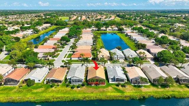 drone / aerial view featuring a residential view and a water view