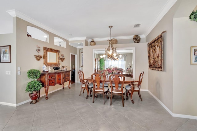 dining room with a notable chandelier, visible vents, baseboards, and ornamental molding