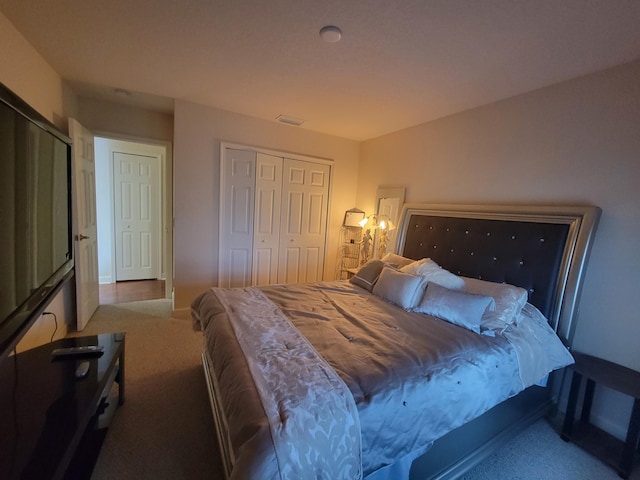 bedroom with visible vents, carpet, and a closet